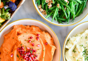 Haricots Verts with Hazelnuts & Orange Zest (top), Brown Sugar & Lime Yams (front left), Creamy Mashed Potatoes (front right)